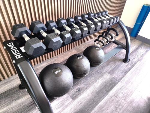 a row of dumbbells in a gym at JD Haven Bachelor's Pad at Bernwood Tower in Iloilo City