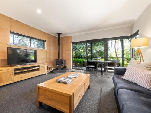 a living room with a couch and a tv at Aroha Studio - Elegant & Tranquil - Self Contained in Margaret River Town