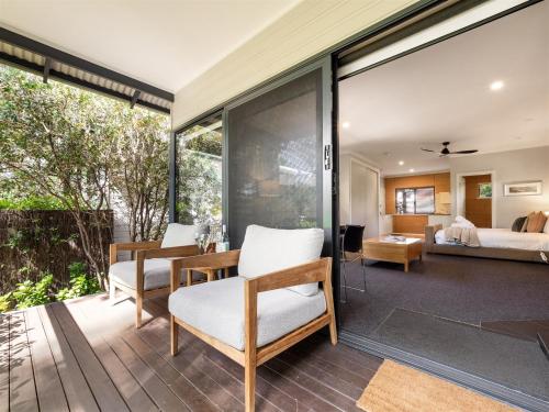 a room with sliding glass doors leading to a bedroom at Aroha Studio - Elegant & Tranquil - Self Contained in Margaret River Town