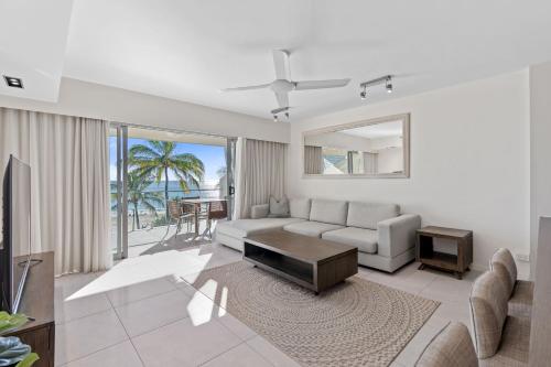 a living room with a couch and a table at Fairshore in Noosa Heads