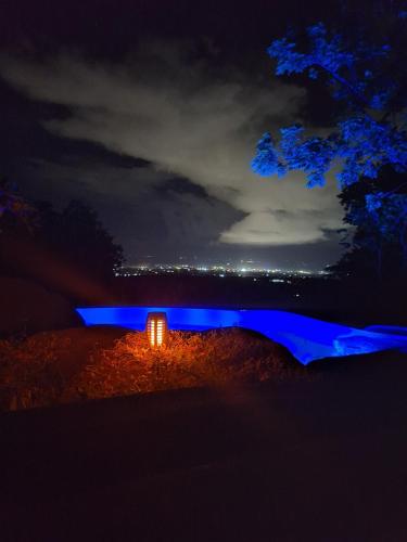 a house lit up at night with blue lights at ecoco rocks in Sibulan