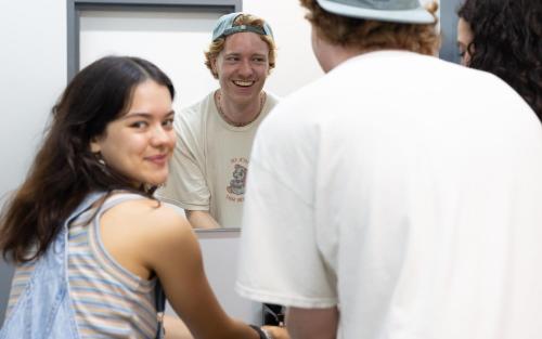 a group of people standing in front of a mirror at Nate's Place Backpackers Sydney in Sydney