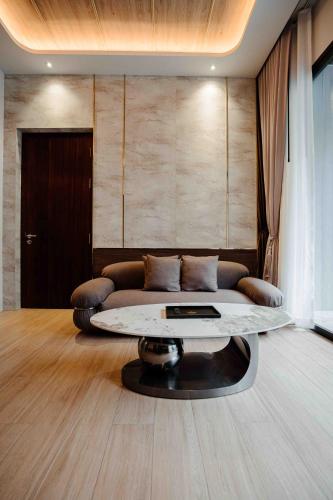 a living room with a couch and a table at Richmann Resort Hotel Hatyai in Hat Yai