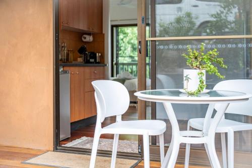 a white table and chairs in a kitchen at Personal Sauna & Ice-bath at Kookaburra Cabin in Mudgeeraba