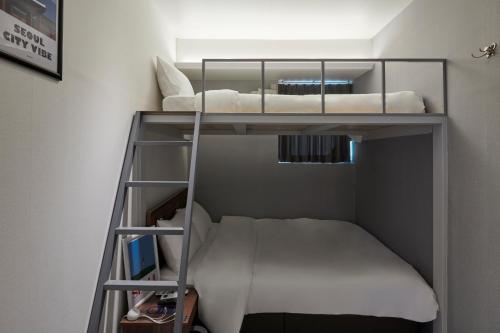 a bunk bed in a small room with a bunk bedscribed at Eight Rest Hostel Jong-ro in Seoul