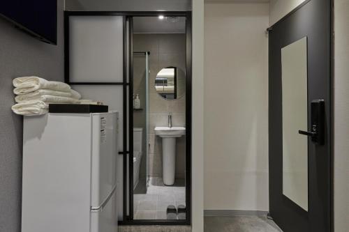 a bathroom with a shower and a toilet and a sink at Eight Rest Hostel Jong-ro in Seoul