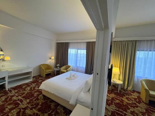 a hotel room with a bed and a desk at ROYAL PARK HOTEL @ UNITEN in Kajang