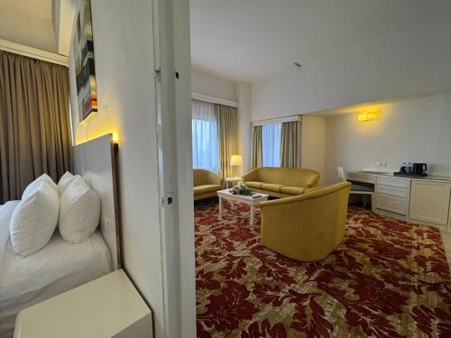 a hotel room with a bed and a couch at ROYAL PARK HOTEL @ UNITEN in Kajang