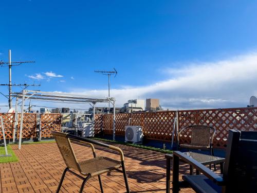 a patio with chairs on a roof at 風花Fuka民泊大森西001 in Tokyo