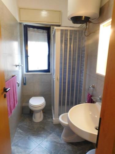 a bathroom with a toilet and a sink at Appartamento presso Residence Erice Beach - Casa Vacanza in Erice