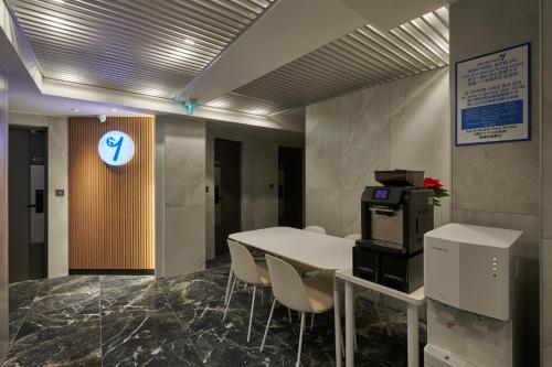 an office with a table and chairs and a printer at Eight Rest Hostel Jong-ro in Seoul
