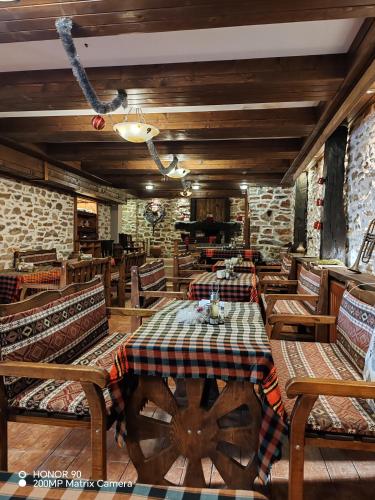 a dining room with a table and chairs and brick walls at Парк - Хотел Макензен in Melnik