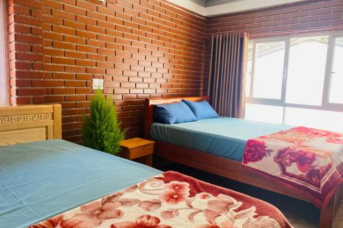 Ένα ή περισσότερα κρεβάτια σε δωμάτιο στο Dalat Note Hostel