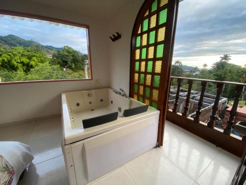 a bathroom with a sink and a window at Mahalo Hostel in Salento