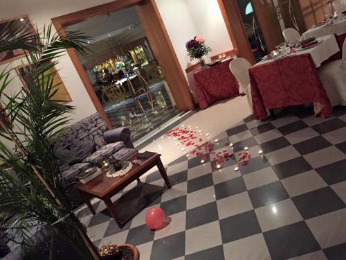 a living room with a couch and a checkerboard floor at Platani Hotel in Bolsena