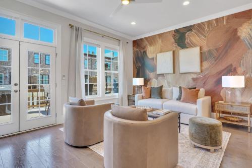 a living room with a couch and chairs at Waterside Retreat, Steps to River Street in Savannah