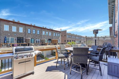 a balcony with a stove and a table and chairs at Waterside Retreat, Steps to River Street in Savannah