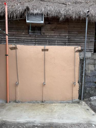 a brown door with a building with a roof at Sand Castles Beachfront Resort in Zambales