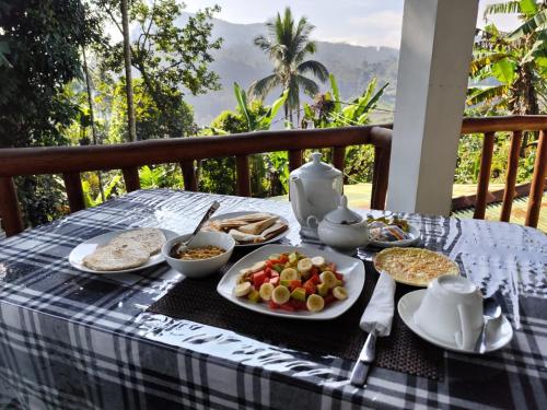a table with a plate of food on a table at Ella Elysium Escapes in Ella