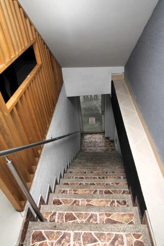 a staircase with a stone floor and wooden walls at DAM Hotel Pereira in Pereira