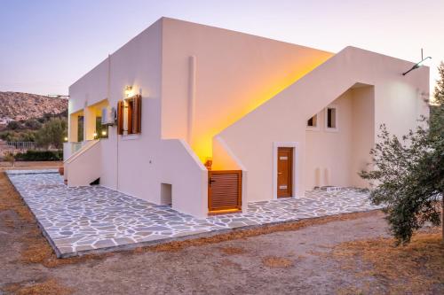 a white house with a rainbow on it at Olive Studios Karpathos Studio #4 in Karpathos Town