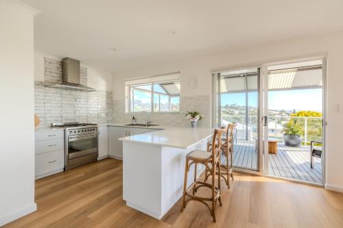a kitchen with white counters and a large window at Seaview Heights by the BnB Collection in Albany