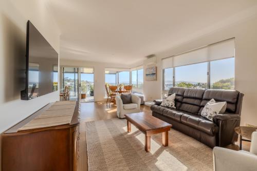 a living room with a couch and a table at Seaview Heights by the BnB Collection in Albany