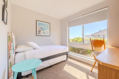 a bedroom with a bed and a desk and a window at Seaview Heights by the BnB Collection in Albany