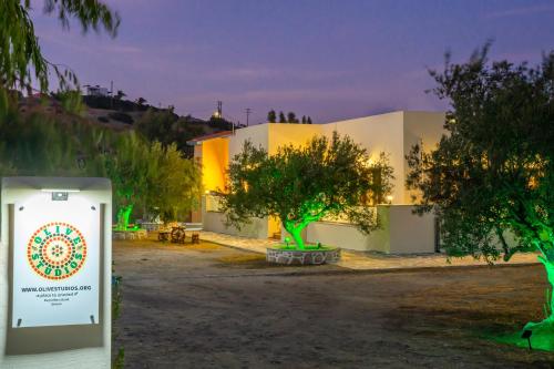 a building with trees and a sign in front of it at Olive Studios Karpathos Studio #4 in Karpathos Town