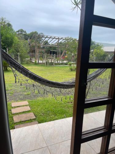 a view of a playground from a window at Chalé Aracuã 2 in Torres