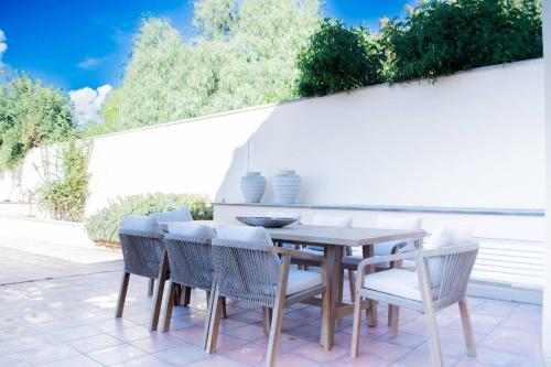 a wooden table and chairs on a patio at Aphrodite Premium Apartments I in Kouklia