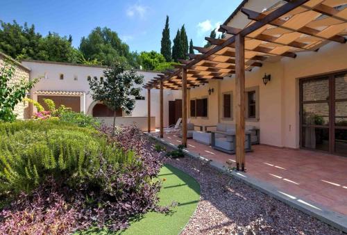 an outdoor patio with a wooden pergola at Aphrodite Premium Apartments I in Kouklia