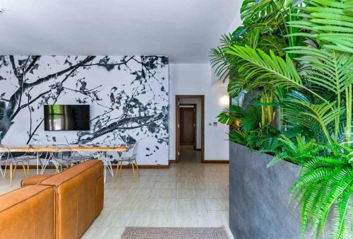 a dining room with a table and some plants at Aphrodite Premium Apartments I in Kouklia