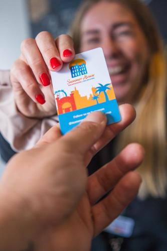 a woman holding up a card in her hands at Summer House Melbourne in Melbourne