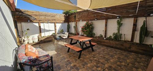 an outdoor patio with a table and a couch at Hostal Sol y Luna in Santiago