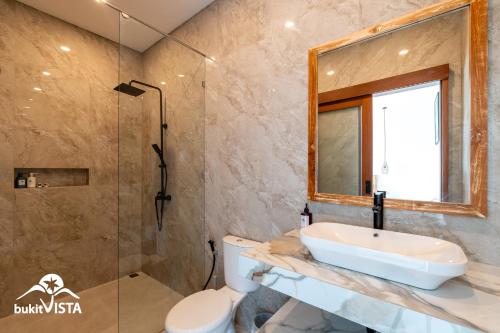 a bathroom with a sink and a toilet and a shower at Agra Villa Bali by Bukit Vista in Uluwatu