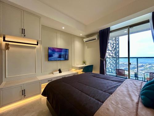 a bedroom with a large bed and a large window at Gold Coast Apartment PIK Luxury Sea View by stay with E in Jakarta