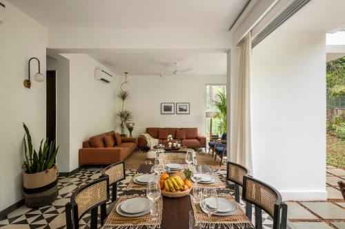 a dining room with a table and chairs at La Olalian 2 & 3 BHK Designer Villas Near Anjuna Beach with Private Pool & Sun Deck & Garden in Anjuna