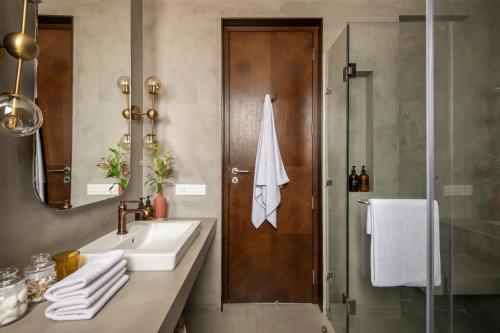 a bathroom with a sink and a shower at La Olalian 2 & 3 BHK Designer Villas Near Anjuna Beach with Private Pool & Sun Deck & Garden in Anjuna