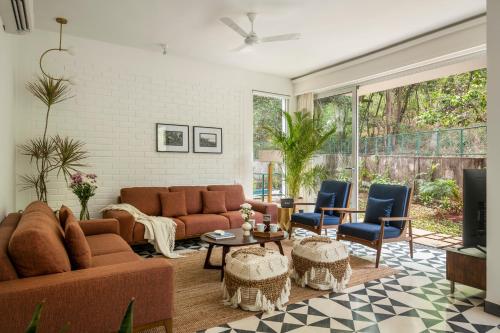 a living room with a couch and chairs at La Olalian 2 & 3 BHK Designer Villas Near Anjuna Beach with Private Pool & Sun Deck & Garden in Anjuna
