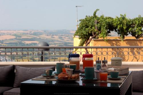 a table with food and drinks on a balcony at Relais Chambre in Castelfidardo