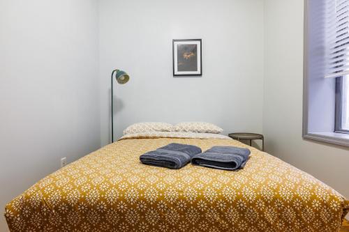 a bedroom with a bed with two towels on it at Inspire the Vibrant Energy of the UWS in New York