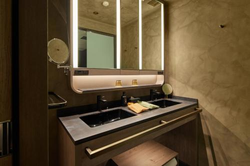 a bathroom with a sink and a mirror at THE HOTEL HIGASHIYAMA KYOTO TOKYU, A Pan Pacific Hotel in Kyoto