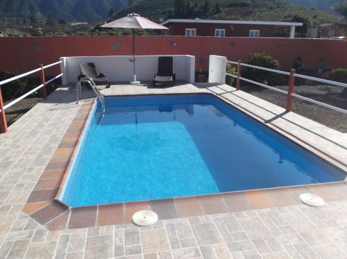 a swimming pool on a patio next to a house at Casa Teresa in El Paso