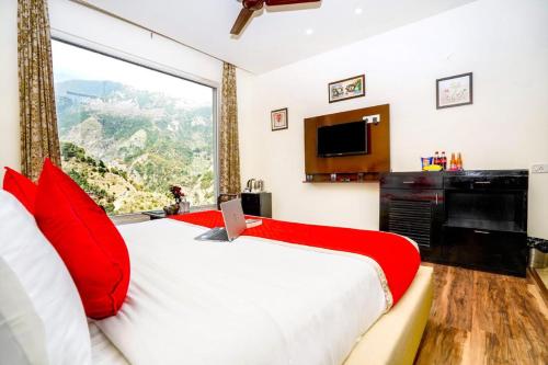 a bedroom with a large bed with a large window at #The Vaikunth# Mcleodganj# Dhauladhaar View# Big free Parking# Ac rooms Centrally#Elevator#Soundproof rooms# in Dharmsala