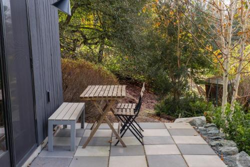 a picnic table and a chair on a patio at Water Mtn Views, Forest Walk To Beach! in Clinton