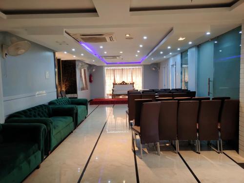 a conference room with green chairs and a table at Geetanjali International in Deoghar