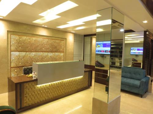 a lobby with a chair and a glass wall at Geetanjali International in Deoghar