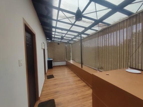 a hallway with a room with wooden floors and a ceiling at Private Cottage Wayanad in Kalpetta
