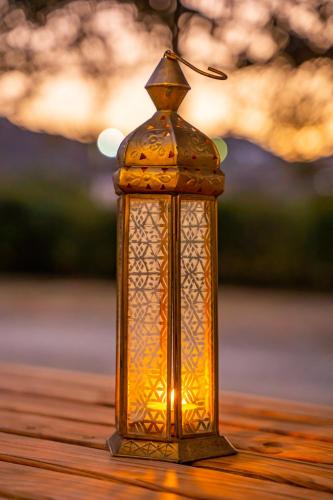 a glass lantern sitting on top of a table at Olive Studios Karpathos Studio #1 in Karpathos Town